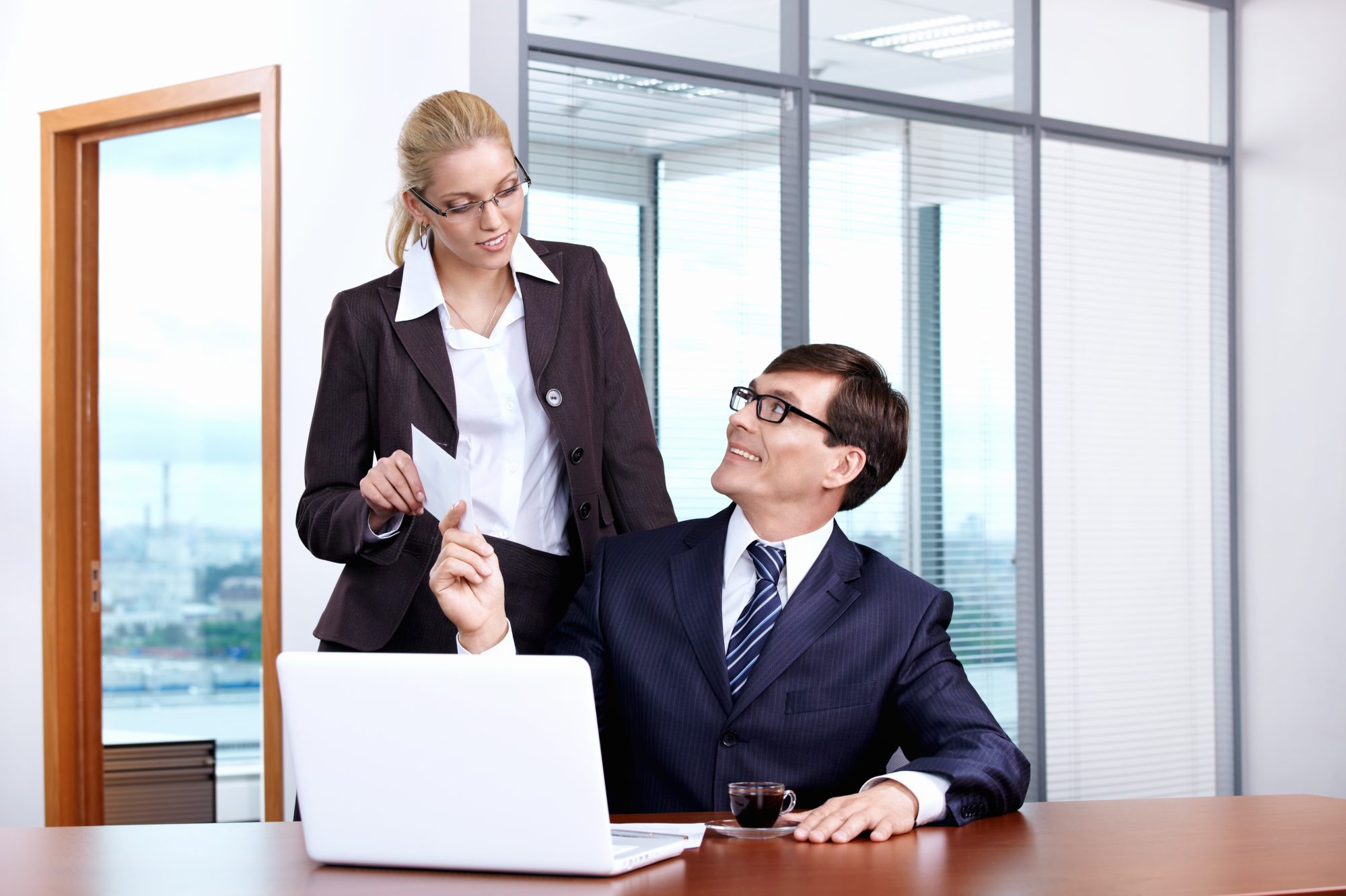 Boss gives the envelope to the secretary in the office